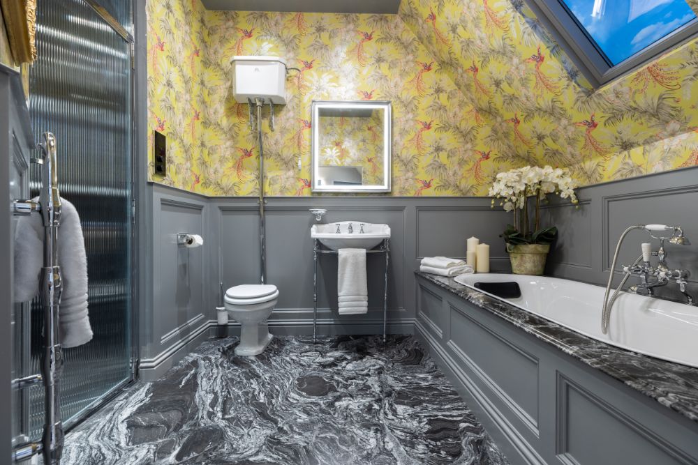 A traditional bathroom with a floral wallpaper design from our tile showroom.