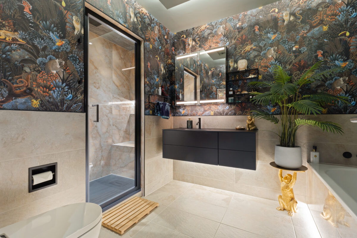 Spa-inspired steam room renovation in Edinburgh, featuring a vanity area, bath, and steam room. A seamless blend of tile and wallpaper adds warmth, texture, and character to the space
