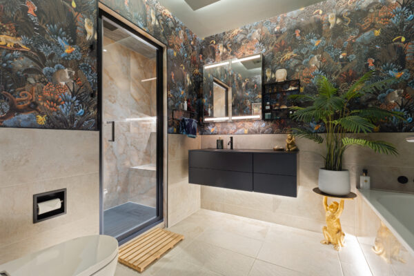 Spa-inspired steam room renovation in Edinburgh, featuring a vanity area, bath, and steam room. A seamless blend of tile and wallpaper adds warmth, texture, and character to the space